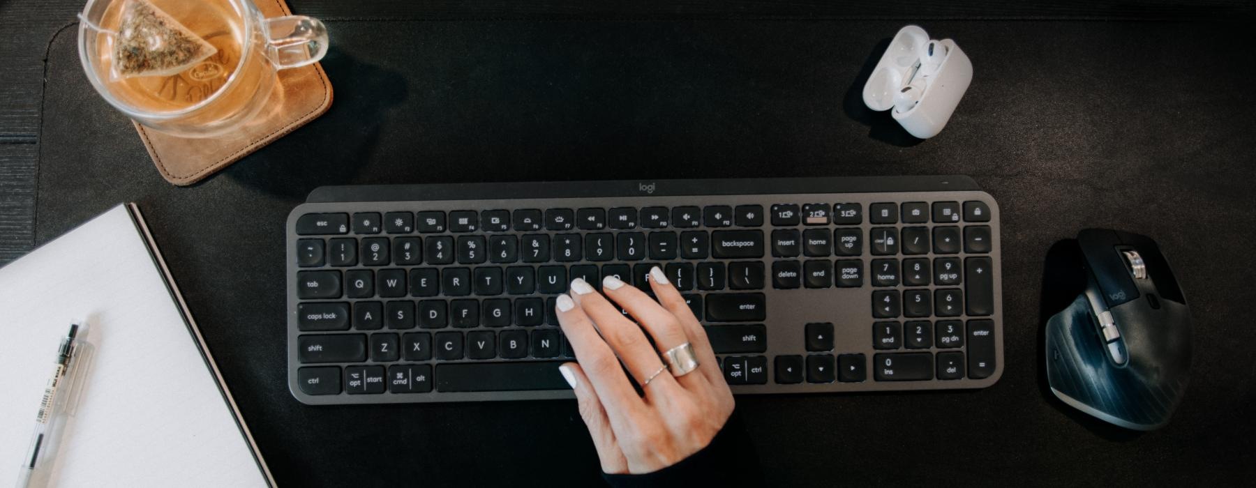 a person typing on a keyboard